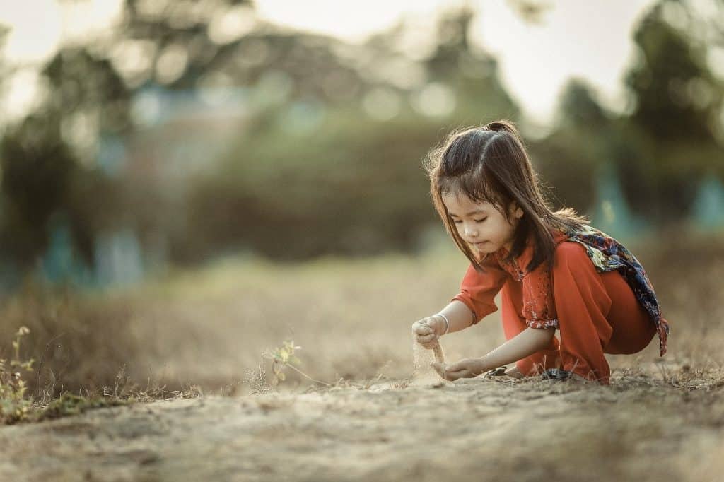 little girl playing with sand