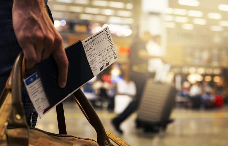 man holding passport in an airport