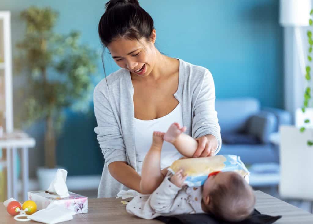 mom changing baby's diaper