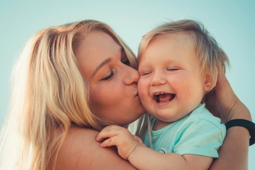 mother kissing her baby