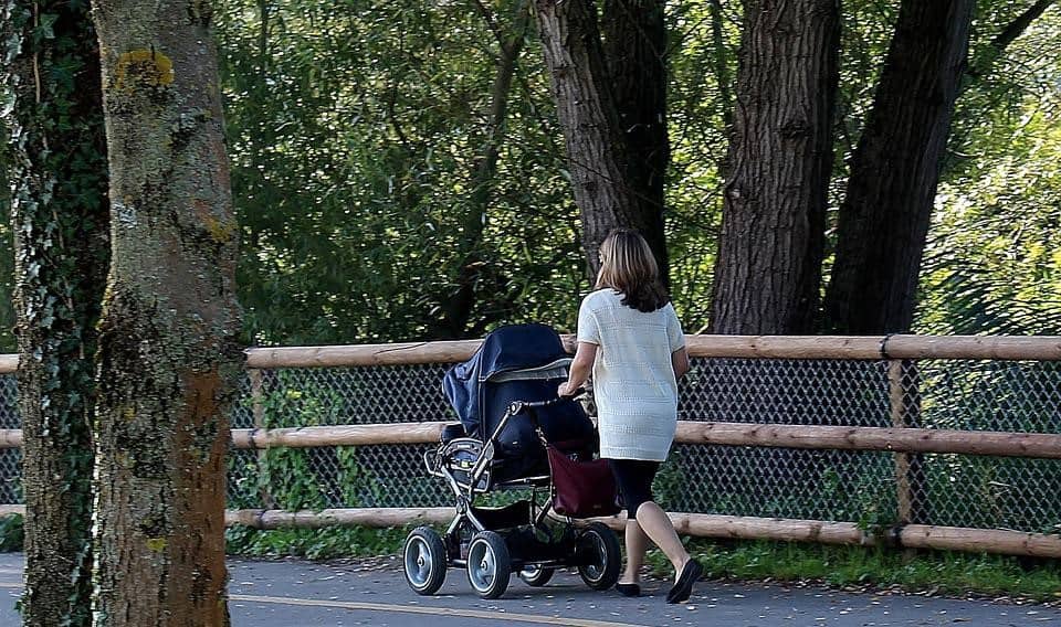 mother strolling baby in the streets