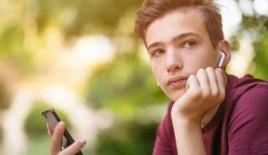 portrait of a teenage boy wearing earpods