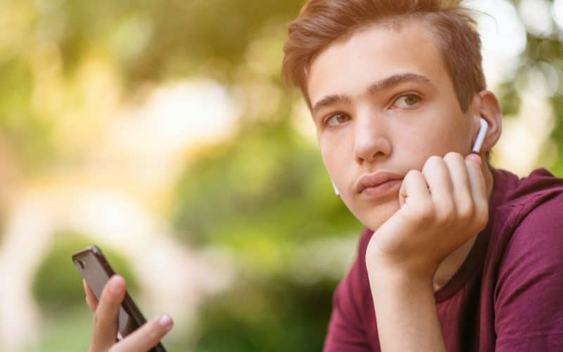 portrait of a teenage boy wearing earpods
