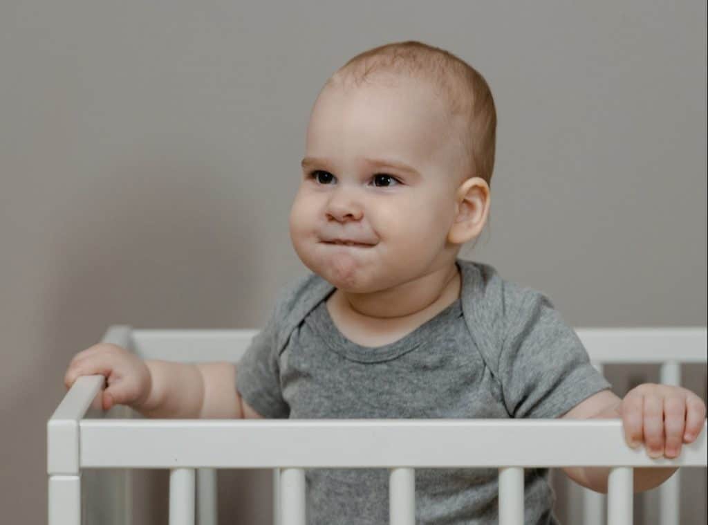 adorable baby standing in a crib