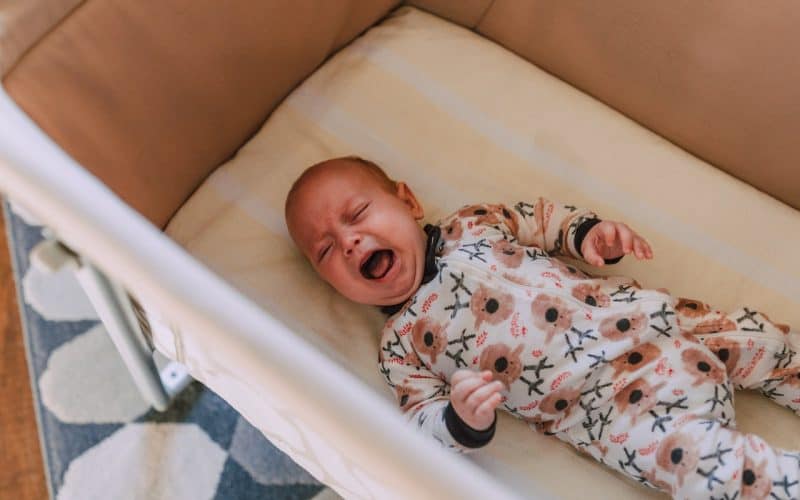 baby crying on a crib