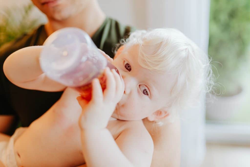 baby drinking milk from bottle