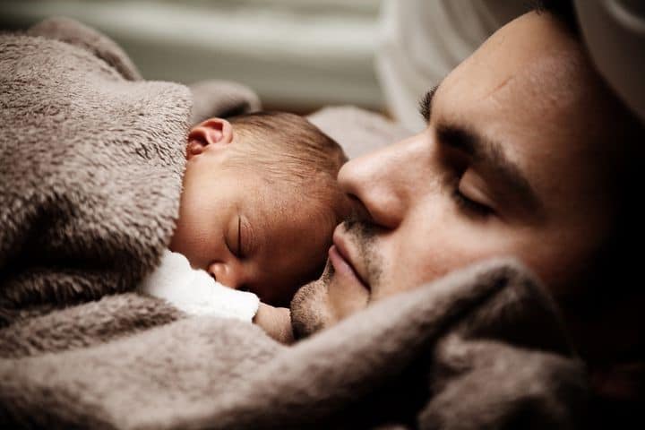 baby sleeping on dad's chest