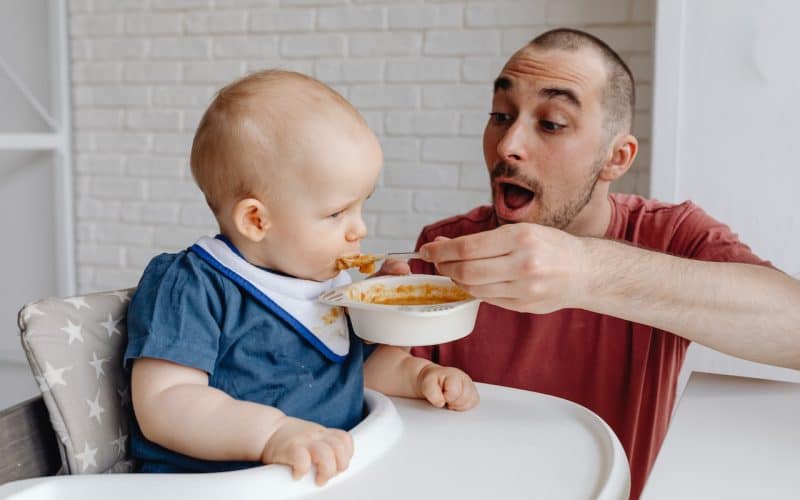 dad feeding baby