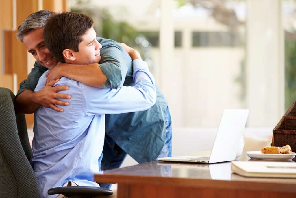 dad hugging son