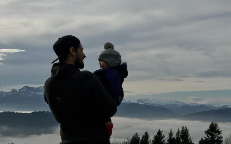 dad talking to baby while outdoors