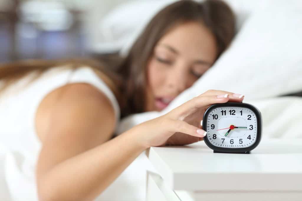 girl hitting snooze button