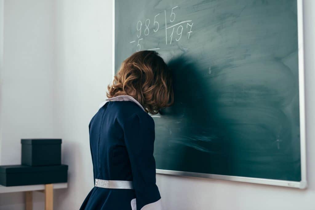 girl with head pressed on a board