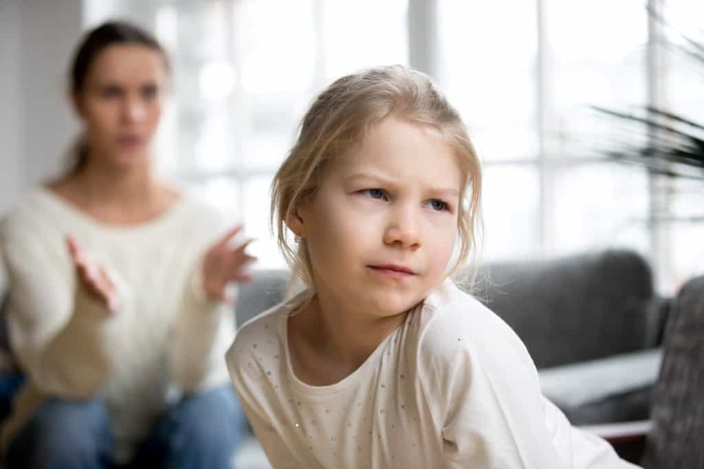 little girl ignoring her mom