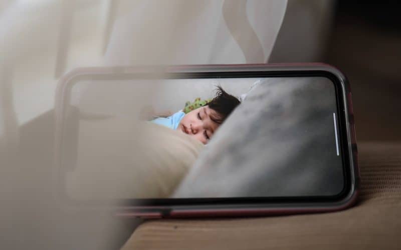 mobile phone with sleeping baby