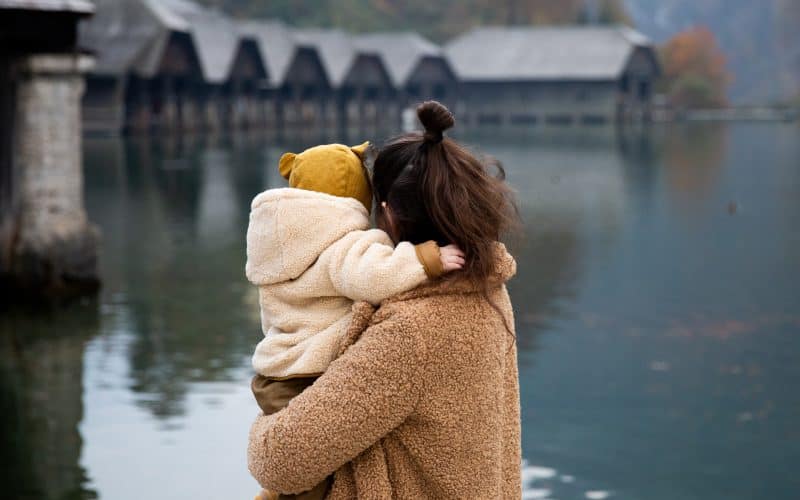 mom and baby looking at the lake