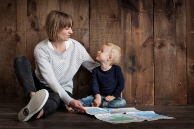 mom and her little boy holding a map