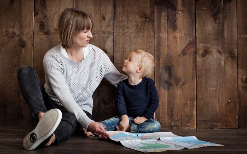 mom and her little boy holding a map