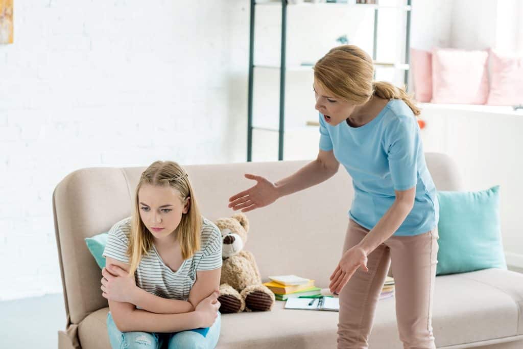mom scolding teenage daughter