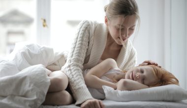 mom tucking in her baby girl