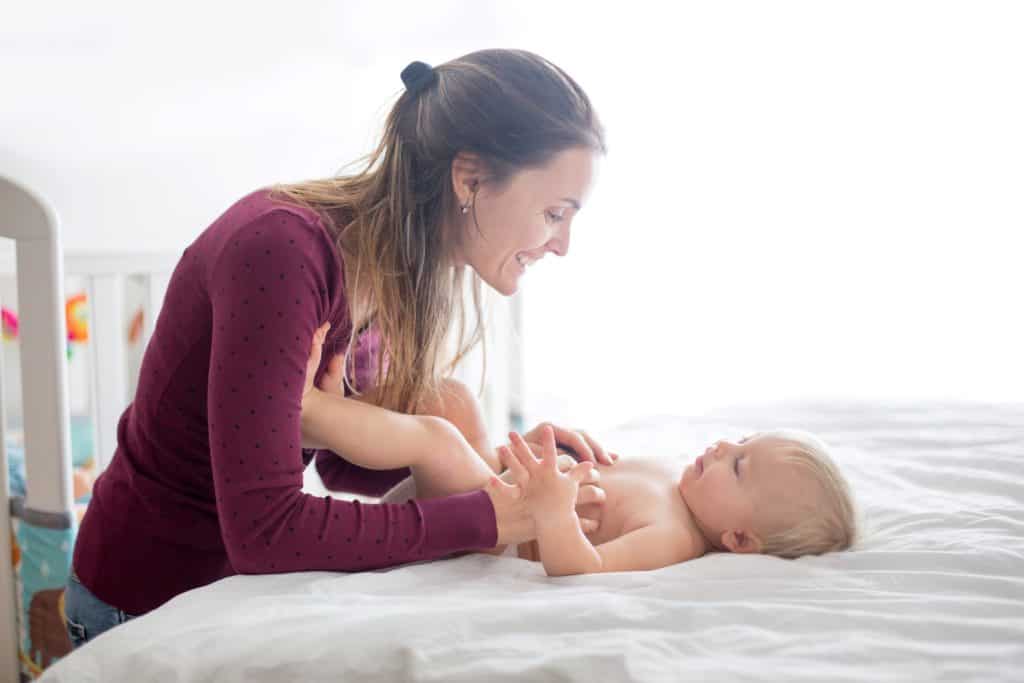 mother entertaining her baby