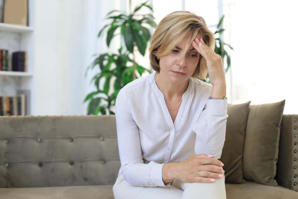 stressed woman touching her head