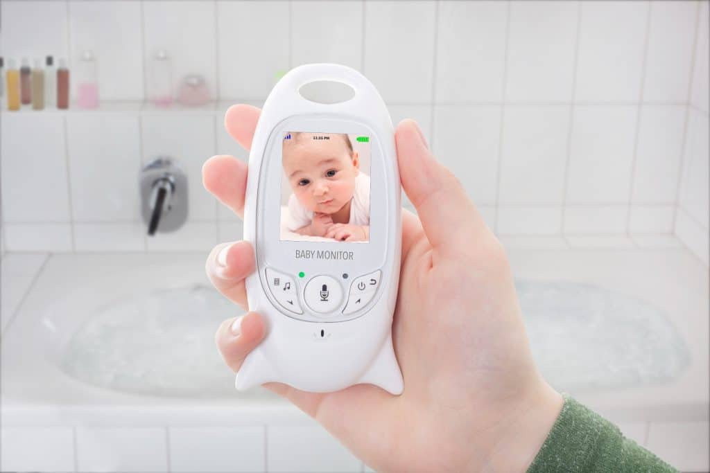 woman's hand holding a baby monitor