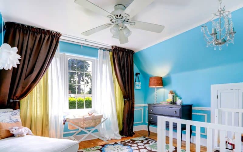 baby's room with ceiling fan