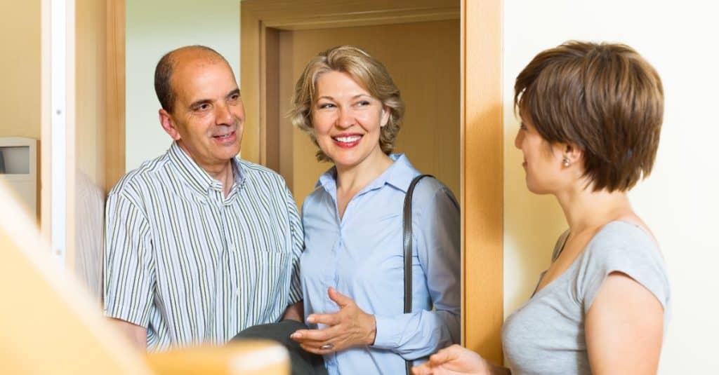 elderly couple visiting woman