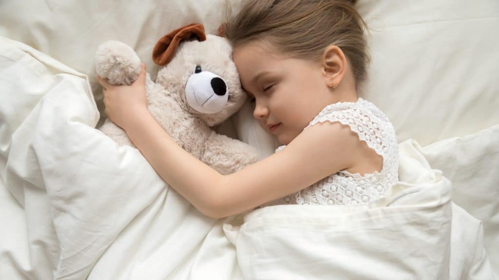 girl sleeping with stuff toy