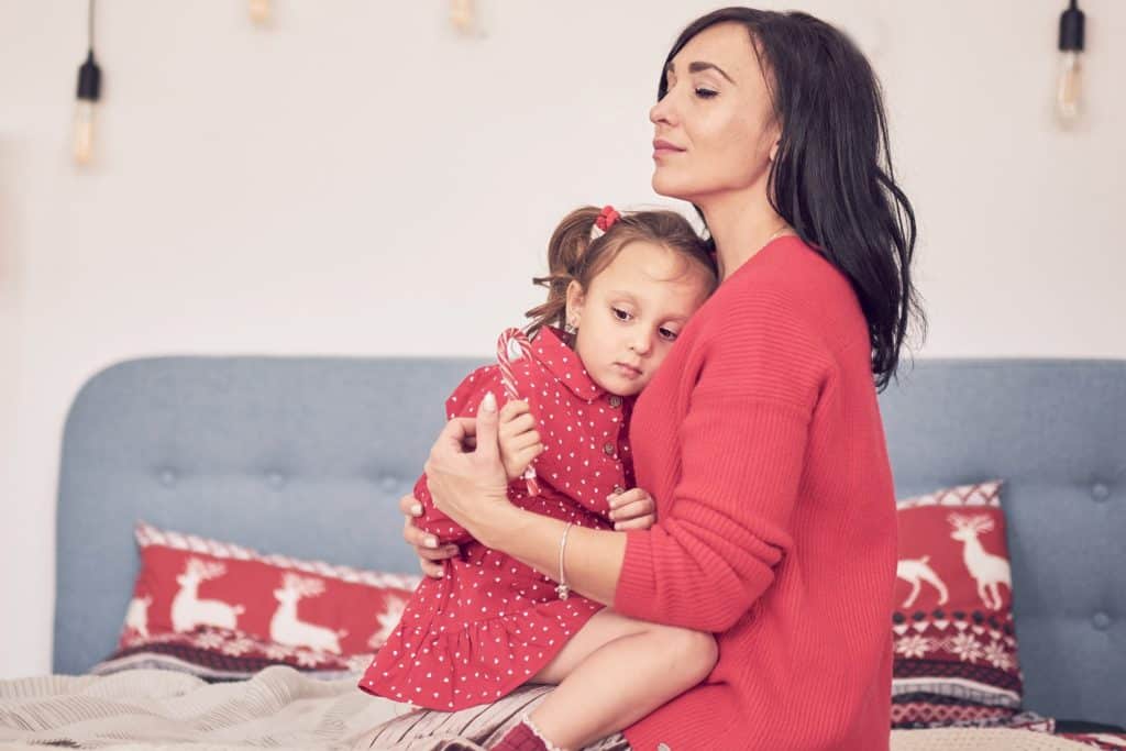 lady hugging a little girl