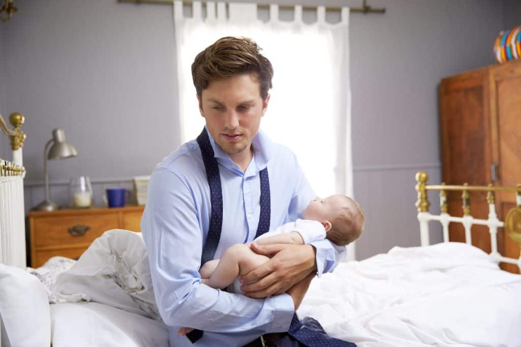 man carrying a baby