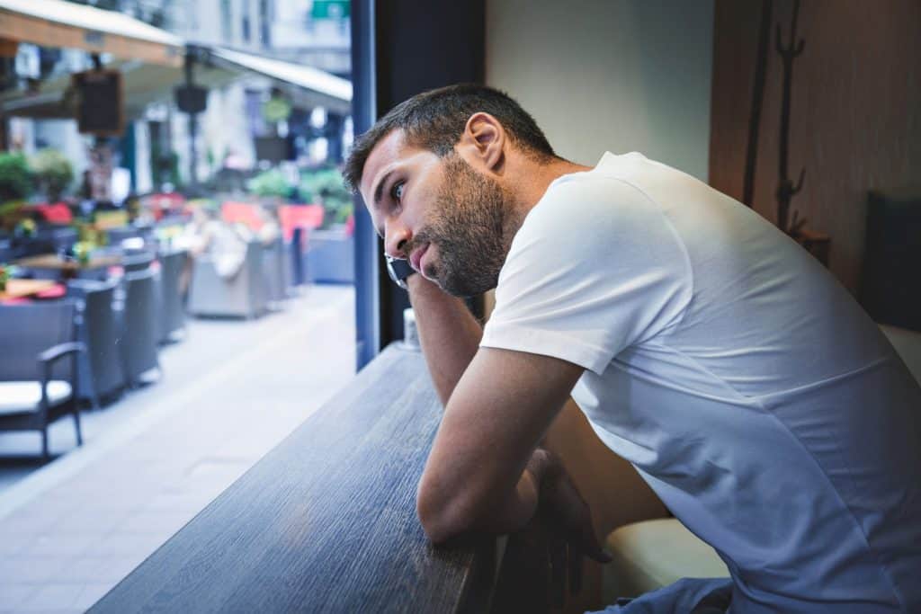 man looking out the window