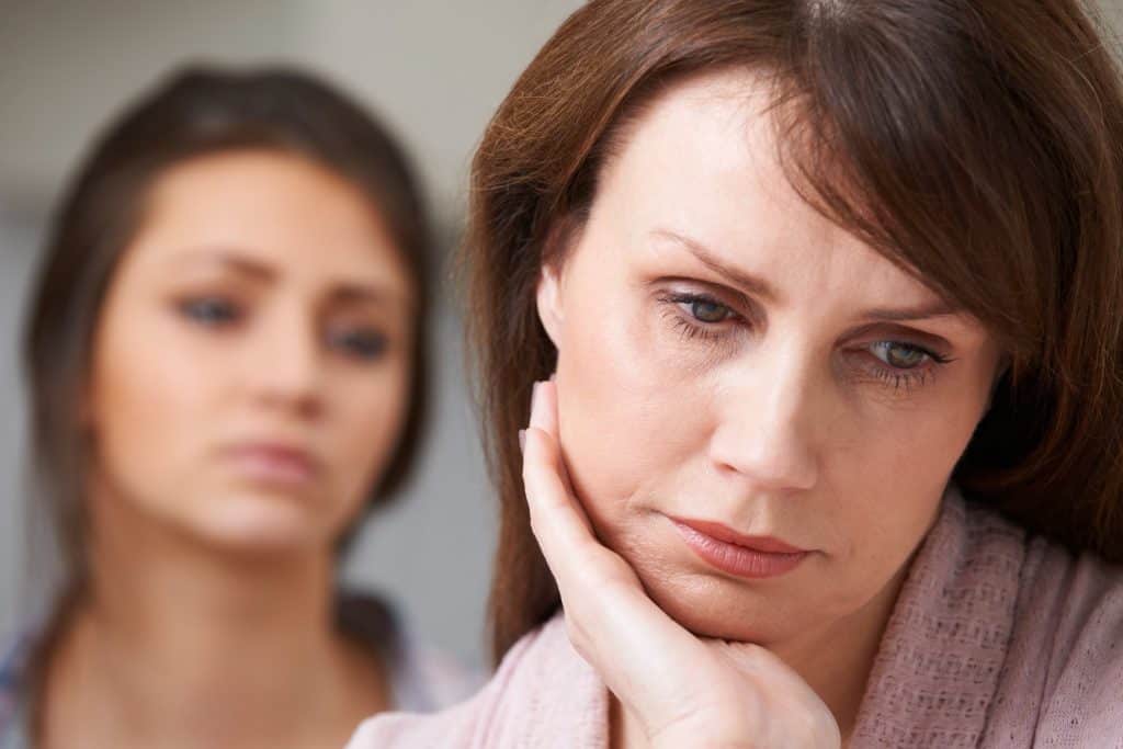 mother and daughter looking sad