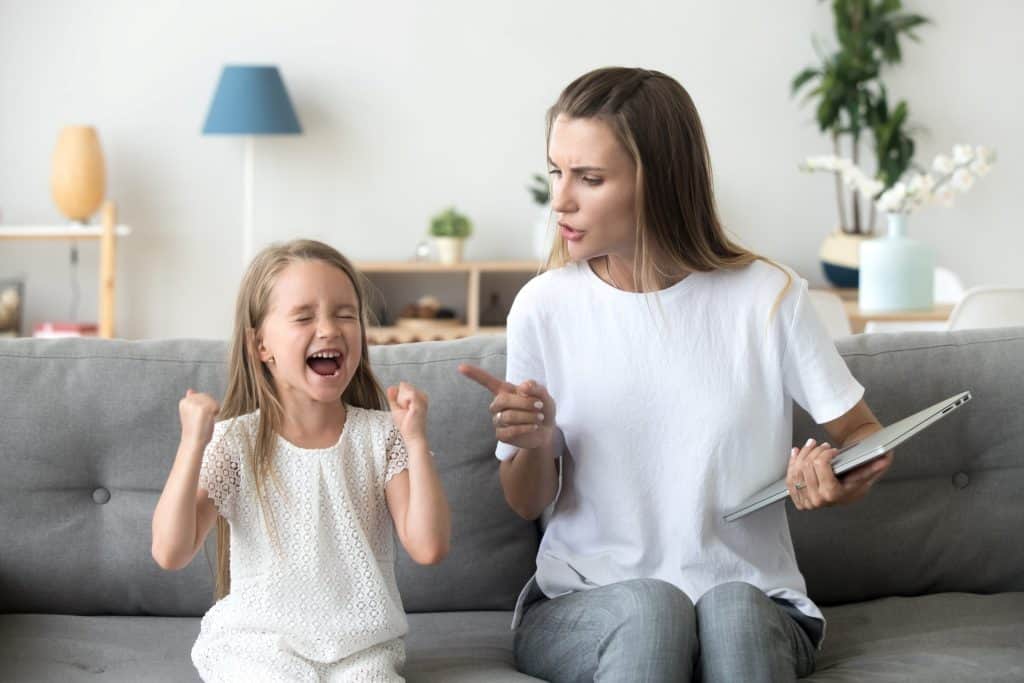 mother shushing a screaming girl