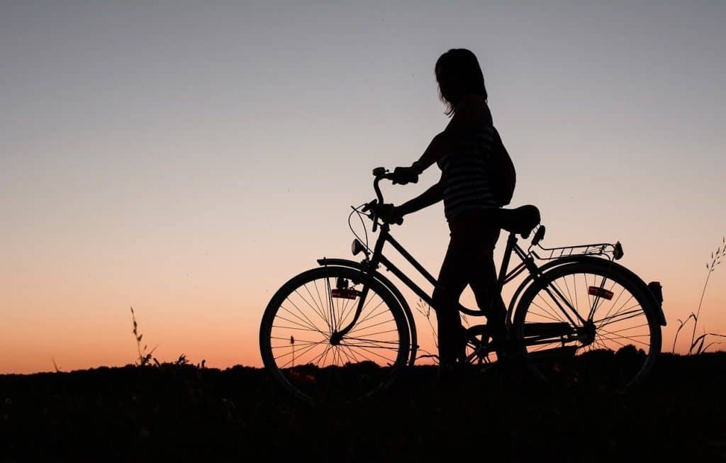 silhoutte of a woman on a bike