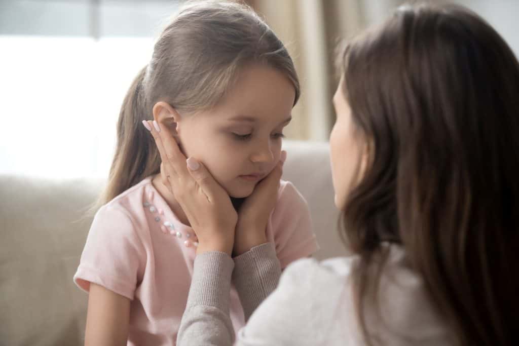 woman talking to a little girl