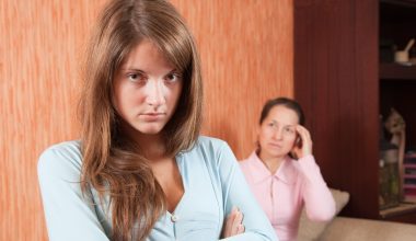 angry teenage girl and stressed out mom