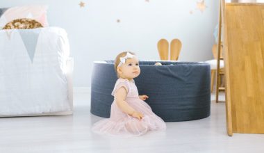 baby girl sitting in a children's room