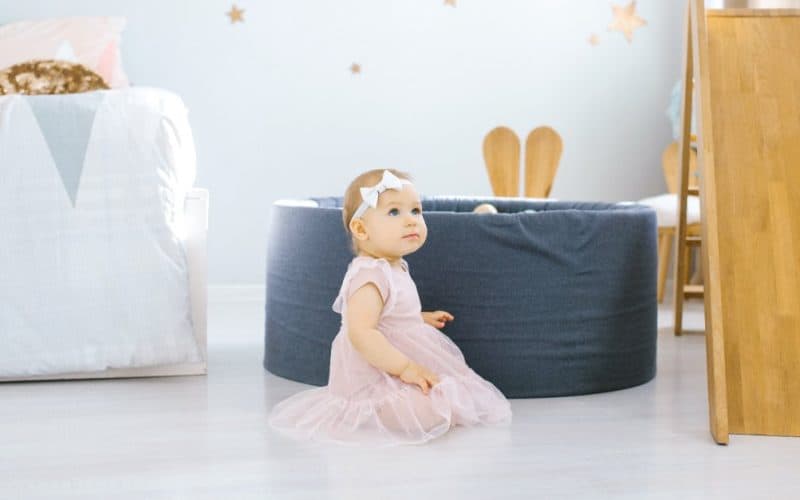 baby girl sitting in a children's room