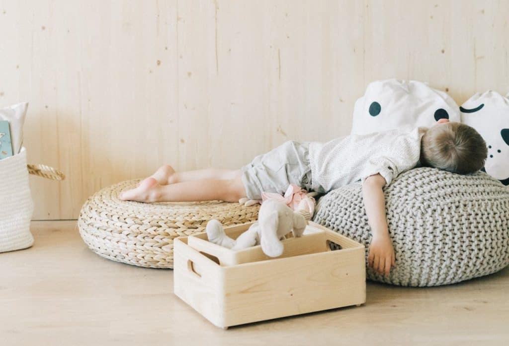 boy laying on a bunch of pillows