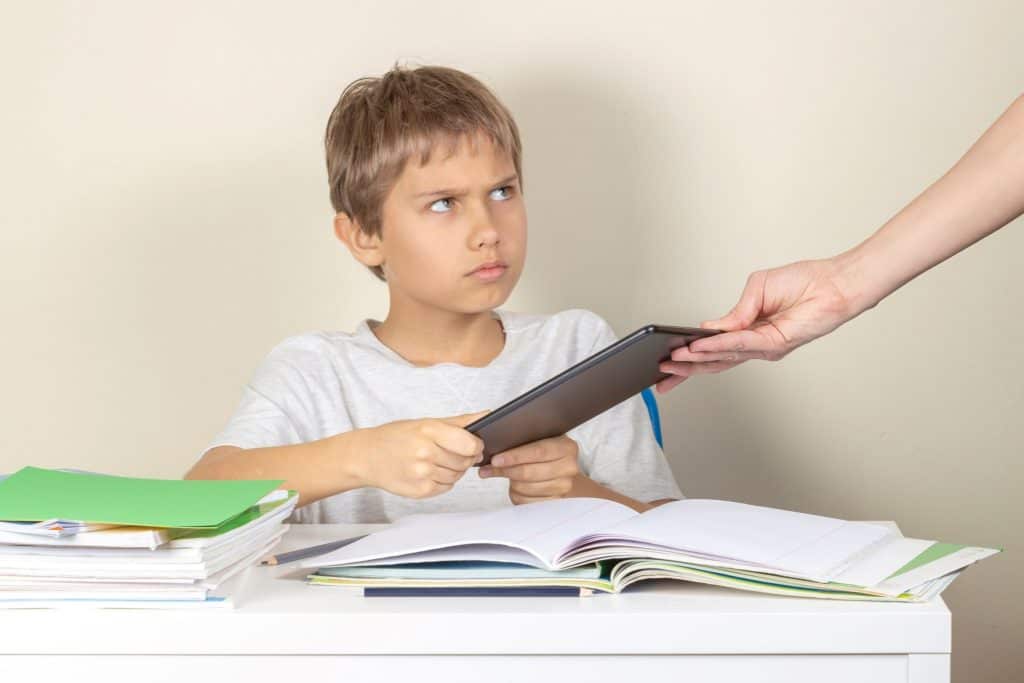 boy refusing to hand over ipad