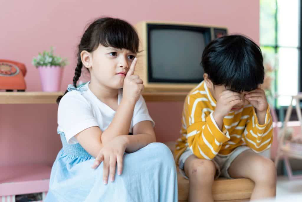 girl sitting beside a crying boy