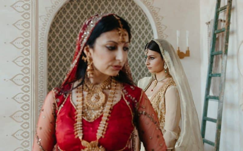 Indian mother standing beside her daughter