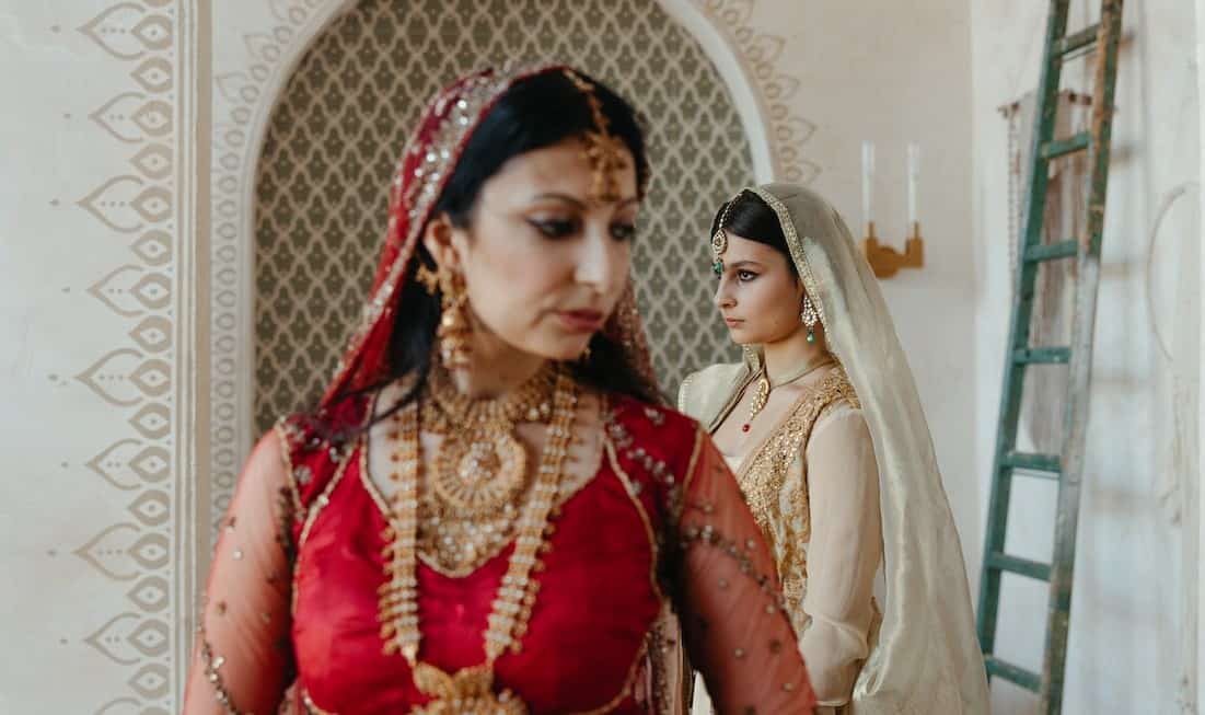 Indian mother standing beside her daughter