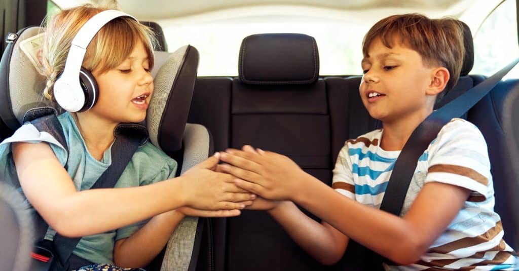 kids playing at the backseat of a car