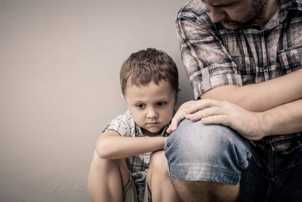 little boy sitting with his dad