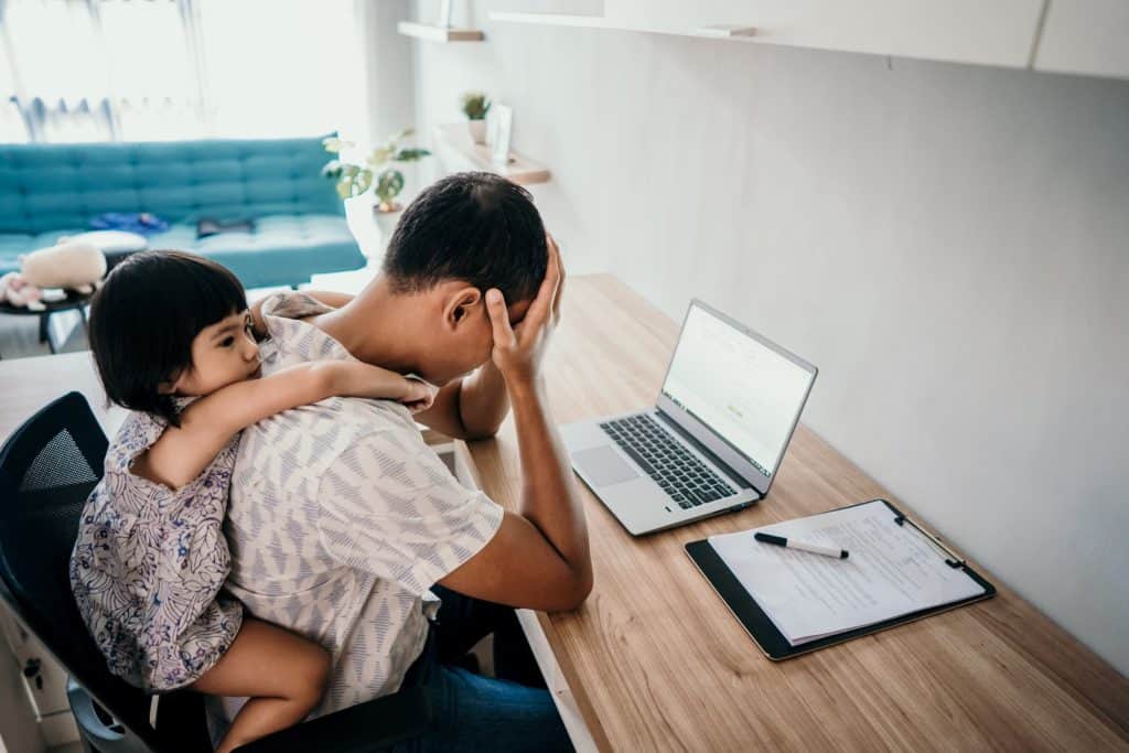 little girl piggybackriding on stressed out dad