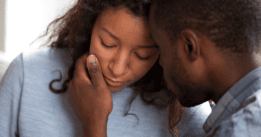 man consoling his wife