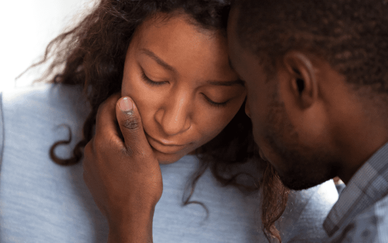 man consoling his wife