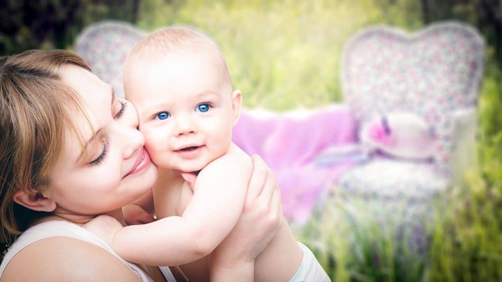 mom pressing cheeks together with baby